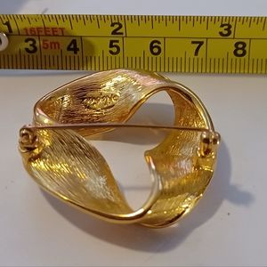 Gold colored broach pin